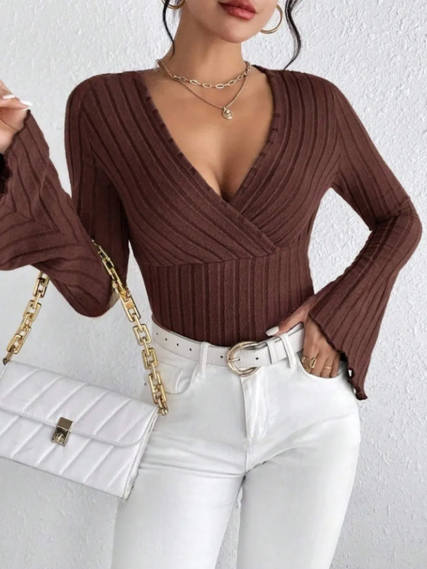 Ribbed Flare Sleeve Top – Slim Fit Knit worn with high-waisted jeans and a chic handbag.