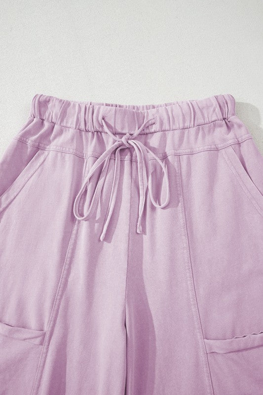 Mineral Wash Reverse Seam Drawstring Elastic Waist in soft lavender color with adjustable waistband and cargo pockets.