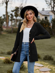 Ribbed Button-Up Cardigan with Pockets worn by a woman outdoors, featuring a v-neck and long sleeves.