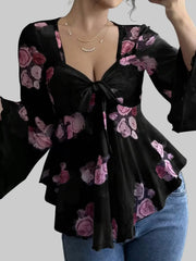 Floral Tie-Front Blouse featuring a v-neckline, flutter sleeves, and a front tie, adorned with pink floral patterns.