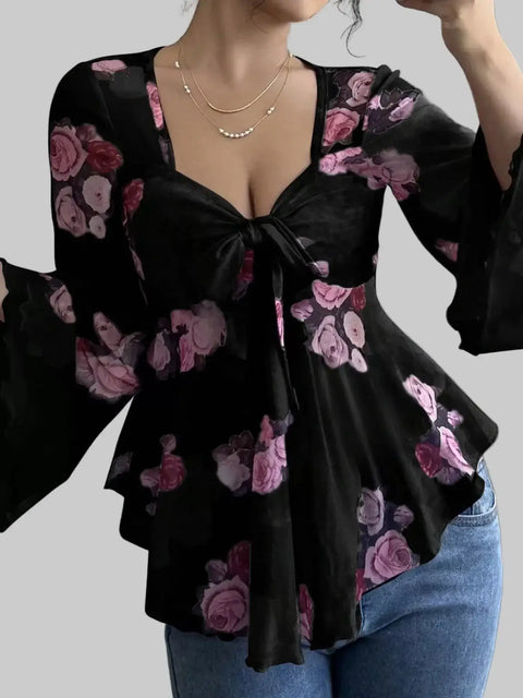 Floral Tie-Front Blouse featuring a v-neckline, flutter sleeves, and a front tie, adorned with pink floral patterns.