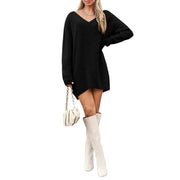 V-Neck Dropped Shoulder Sweater Dress – Cozy Knit Style in black, worn with knee-high white boots, featuring a relaxed fit.