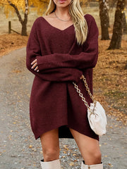 V-Neck Dropped Shoulder Sweater Dress – Cozy Knit Style worn by model in fall setting with autumn leaves.