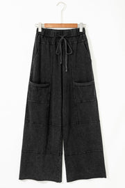 Mineral Wash Reverse Seam Drawstring Elastic Waist cargo pants with exposed seams and adjustable waistband.