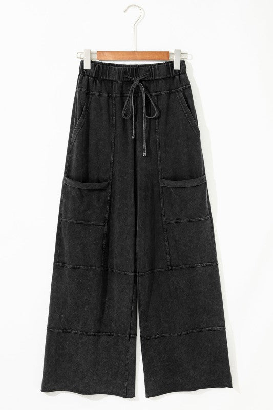 Mineral Wash Reverse Seam Drawstring Elastic Waist cargo pants with exposed seams and adjustable waistband.