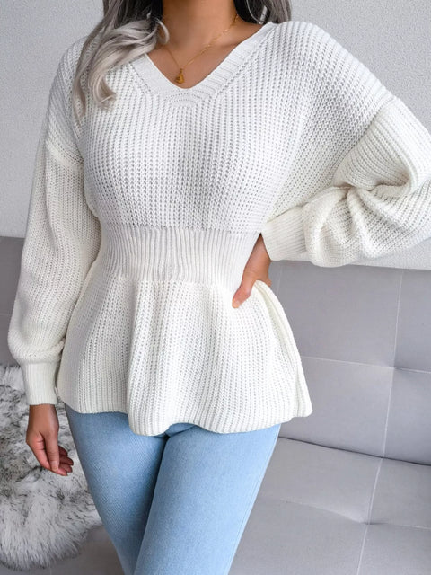 Model wearing a V-Neck Dropped Shoulder Sweater with peplum detail, highlighting its soft white texture.