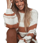Maggie Striped Knit Oversized Sweater with Puff Sleeves worn by a smiling woman, featuring a chic striped pattern.