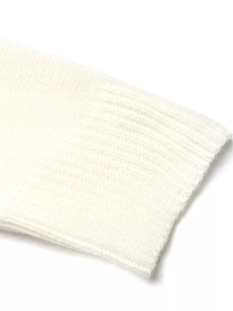 A model wearing a Cozy Geometric Knit Round Neck Sweater, paired with light blue jeans and white sneakers, posing with a brown handbag.