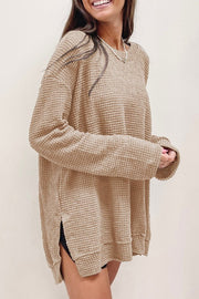 Waffle Knit Drop-Sleeve Side-Slit Oversized Top in beige worn by a smiling woman, featuring a relaxed fit and cozy texture.