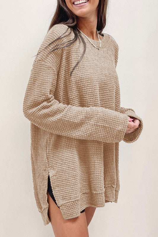 Waffle Knit Drop-Sleeve Side-Slit Oversized Top in beige worn by a smiling woman, featuring a relaxed fit and cozy texture.