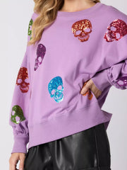Halloween Colorful Skull Sequin Oversized Sweatshirt featuring vibrant sequin skulls on a purple background.