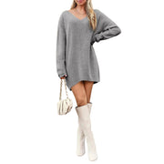 V-Neck Dropped Shoulder Sweater Dress – Cozy Knit Style worn with knee-high boots and a handbag.