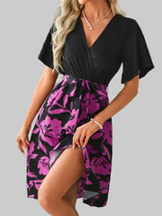 Model in black and purple floral Printed Tie-Waist Mini Dress posing casually – mid-length style