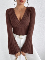 Ribbed Flare Sleeve Top – Slim Fit Knit with flared sleeves and ribbed texture, styled with white high-waisted jeans.