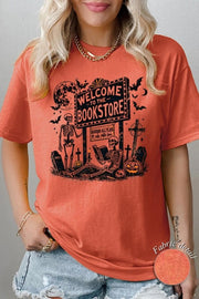 Bookstore Skeleton Halloween Graphic Heavy Cotton Tee on a model, celebrating spooky season with a playful design.