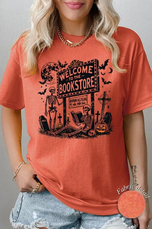 Bookstore Skeleton Halloween Graphic Heavy Cotton Tee on a model, celebrating spooky season with a playful design.