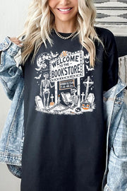 Model wearing Bookstore Skeleton Halloween Graphic Heavy Cotton Tee with spooky skeleton design.