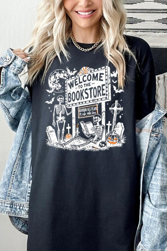 Model wearing Bookstore Skeleton Halloween Graphic Heavy Cotton Tee with spooky skeleton design.