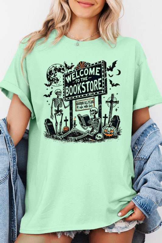 Bookstore Skeleton Halloween Graphic Heavy Cotton Tee with vibrant skeleton design and spooky bookstore sign.