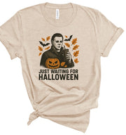 Just Waiting Halloween Graphic Tee featuring a spooky graphic on a soft cotton shirt, perfect for October.
