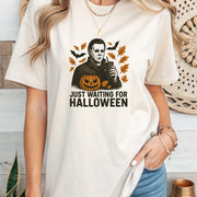 Just Waiting Halloween Graphic Tee featuring a bold graphic of a spooky character with a pumpkin design.