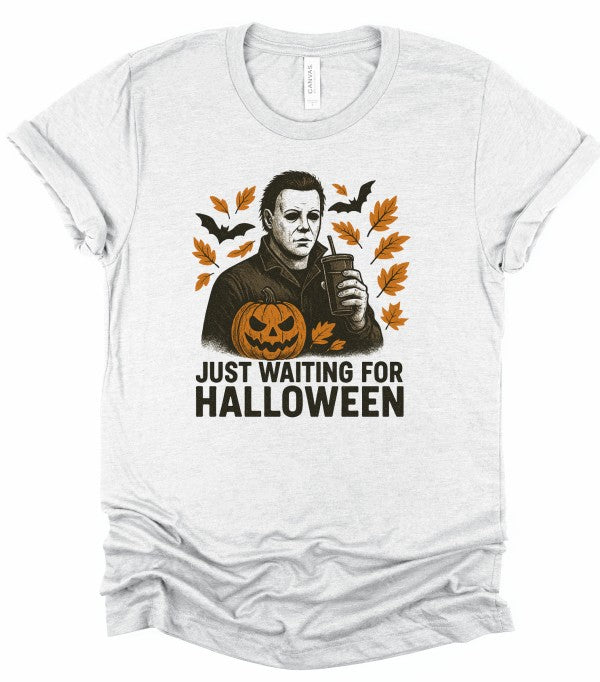 Just Waiting Halloween Graphic Tee featuring a spooky design with autumn leaves and a pumpkin.