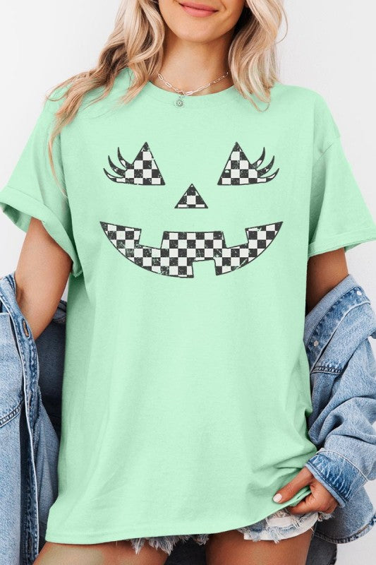 Checker Pumpkin Face Graphic Heavy Cotton Tee featuring a playful pumpkin face design on a mint green shirt.