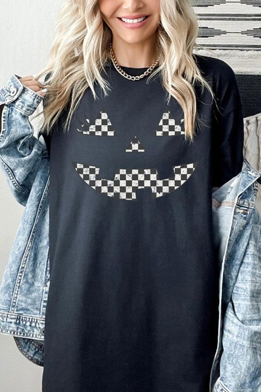 Woman wearing Checker Pumpkin Face Graphic Heavy Cotton Tee with a playful pumpkin face design.