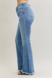 Judy Blue High Waist Flare Fray Hem Jeans with Pintuck Detail styled in a side view, showcasing a chic retro silhouette.