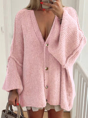 Buttoned Blouse in pink, featuring a cozy oversized design with deep V-neck and stylish button details.