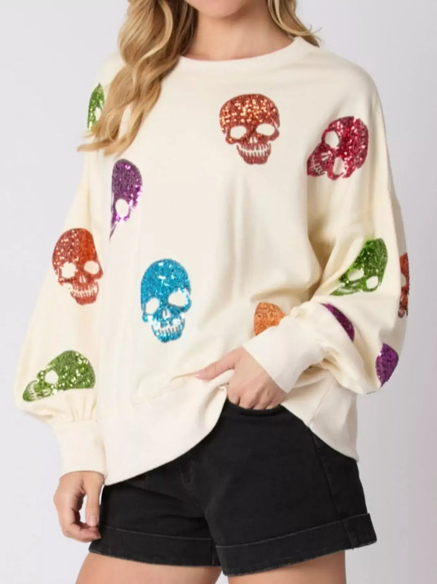 Halloween Colorful Skull Sequin Oversized Sweatshirt with vibrant sequin skulls on a cream background.