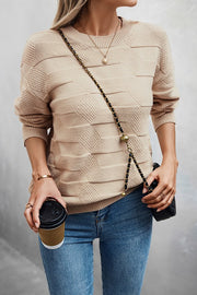 Classic Round Neck Loose Knit Sweater worn casually with coffee in hand, styled with jeans and a crossbody bag.