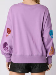 Halloween Colorful Skull Sequin Oversized Sweatshirt back view with sequin skulls on sleeves