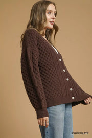 Pearl Button Cable Knit Cardigan in chocolate color, featuring pearl buttons and a cozy cable knit texture.