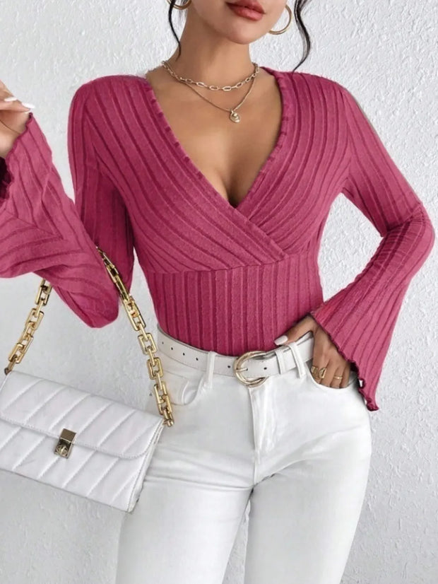 Ribbed Flare Sleeve Top in pink with a v-neck and flared sleeves, paired with white jeans and a stylish handbag.