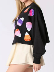 Halloween Candy Sequin Long-Sleeve Sweatshirt featuring colorful candy corn sequins on a cozy black fabric.