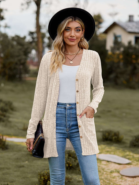Ribbed Button-Up Cardigan with Pockets displayed outdoors, styled with a hat and paired with jeans.