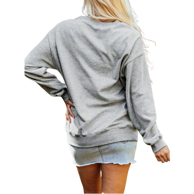 Back view of a cozy graphic sweatshirt paired with a denim skirt, perfect for casual outings.
