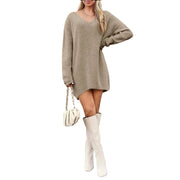 V-Neck Dropped Shoulder Sweater Dress – Cozy Knit Style worn with white boots and handbag.
