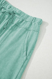 Mineral Wash Reverse Seam Drawstring Elastic Waist cargo pants in mint green, showcasing a comfortable waistband and pockets.
