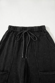 Mineral Wash Reverse Seam Drawstring Elastic Waist black cargo pants with adjustable waistband and pockets.