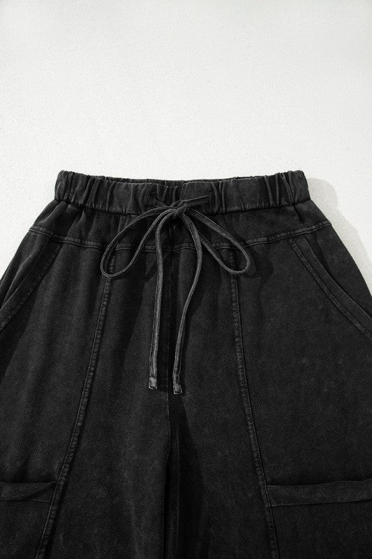 Mineral Wash Reverse Seam Drawstring Elastic Waist black cargo pants with adjustable waistband and pockets.