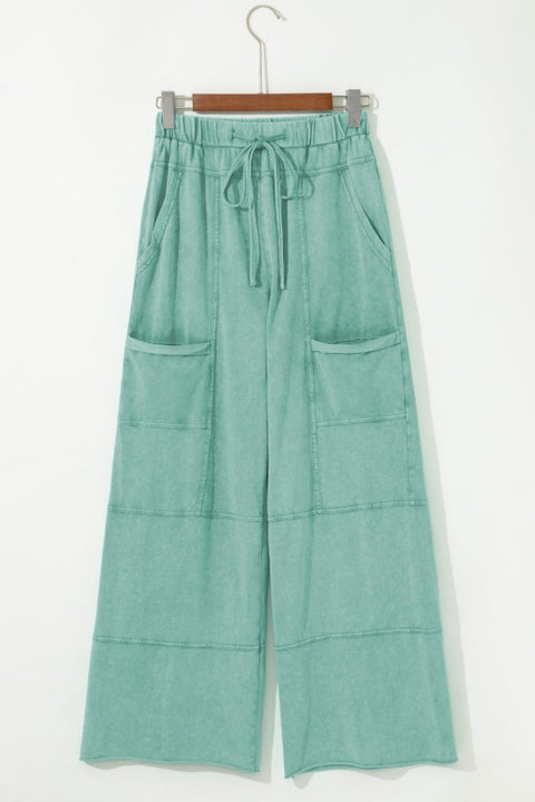 Mineral Wash Reverse Seam Drawstring Elastic Waist cargo pants with wide legs and functional pockets.