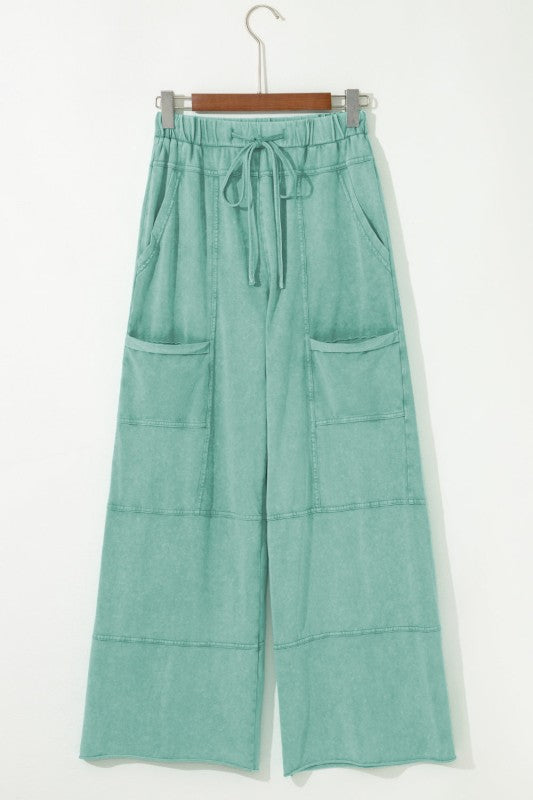 Mineral Wash Reverse Seam Drawstring Elastic Waist cargo pants with wide legs and functional pockets.