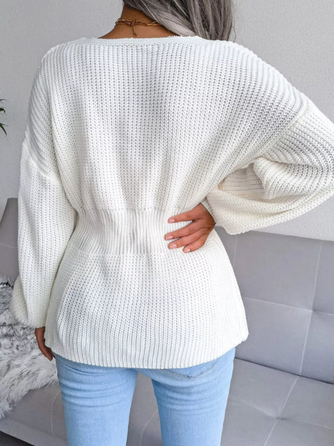 Back view of a woman wearing a white V-Neck Dropped Shoulder Sweater, showcasing its ribbed texture and peplum style.