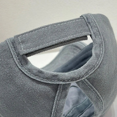 Close-up of the back strap detail of a grey view of the Star Embroidered Baseball Cap showcasing soft cotton material and stitching details.