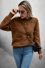 Classic Round Neck Loose Knit Sweater worn with jeans and sunglasses, showcasing textured fabric and relaxed fit.