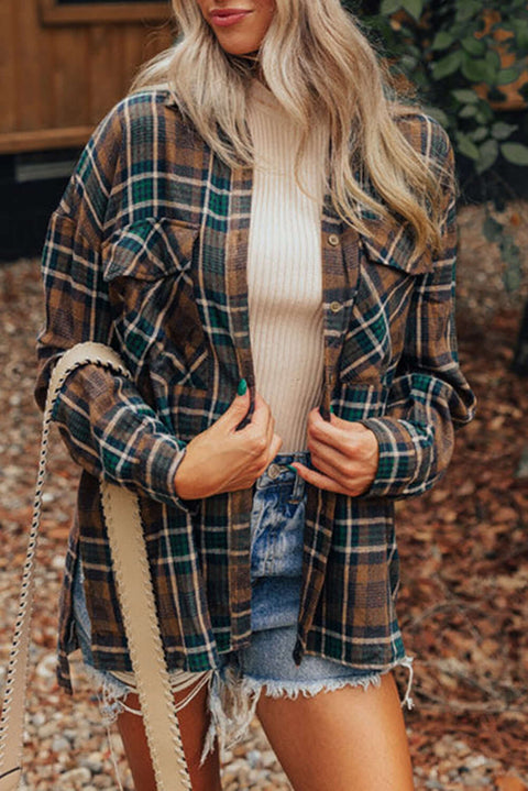 Woman wearing brown plaid button-up shacket over white tee outdoors in a cozy fall outfit