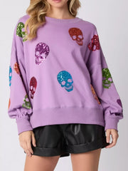 Halloween Colorful Skull Sequin Oversized Sweatshirt with vibrant skulls on a purple background.