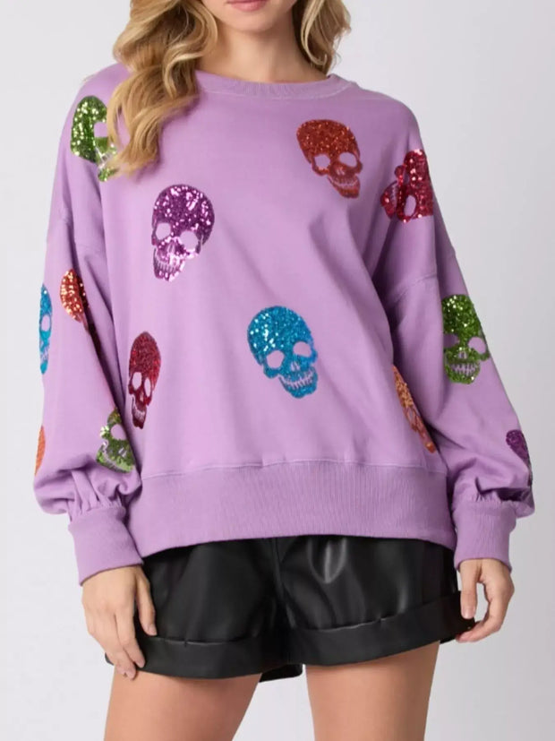 Halloween Colorful Skull Sequin Oversized Sweatshirt with vibrant skulls on a purple background.